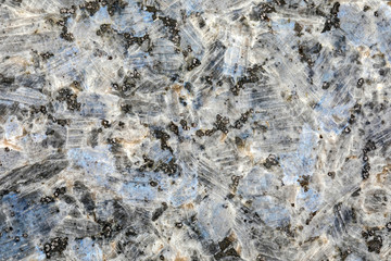 Granite, basalt or marble stone crystal texture of polished gravestone. The macro shot is made by means of stacking technology
