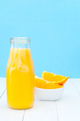 Obraz na płótnie Canvas Close up view of glass bottle with orange juice
