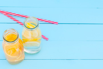 Top view of glass bottles with a detoz water on a blue background