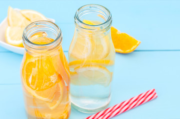 Fototapeta na wymiar Top view of a glass bottles with lemon and orange detox water