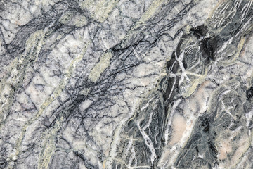 Granite, basalt or marble stone crystal texture of polished gravestone. The macro shot is made by means of stacking technology