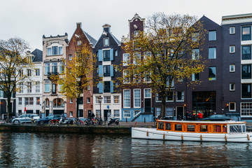 Obraz premium Architecture Of Dutch Houses Facade and Houseboats On Amsterdam Canal