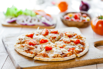hot fresh homemade traditional italian pizza on wooden table. wallpaper for pizzeria and cooking food concept. closeup