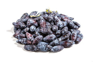 Pile of  Blue honeysuckle (Lonicera caerulea) or Haskap berry isolated on white background.