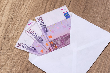 Open an envelope with euro banknotes on the table