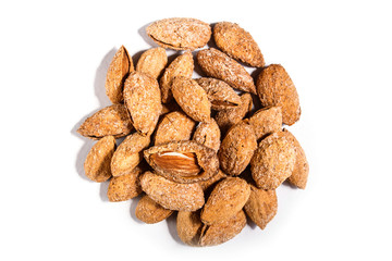 Pile of sweet almond nut with shell and salt isolated on white background.