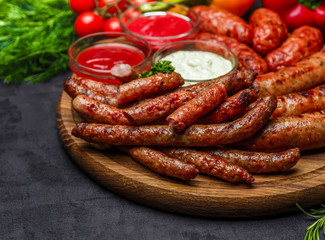 Grilled sausages. Closeup of sausage on the grill. Home-made Sausages. Bavarian sausages