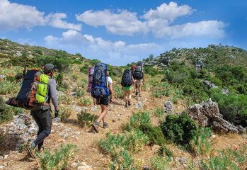 group of tourists goes through the ancient ruins of tombs in Sidima.Turkey