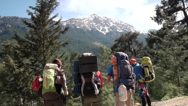 Friends hiking together on Lycian way with Olympos mount on background in Turkey