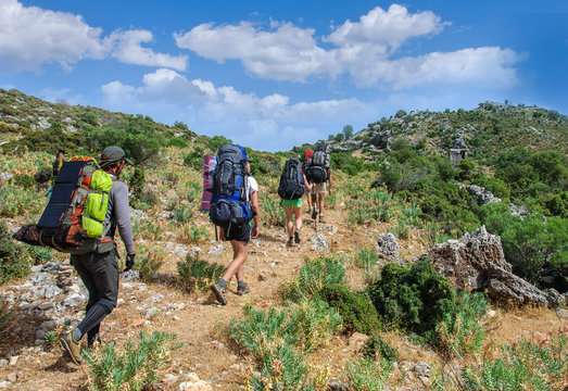 group of tourists goes through the ancient ruins of tombs in Sidima.Turkey