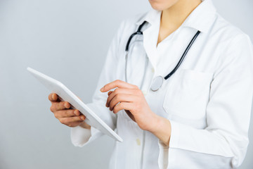 Female doctor work on digital tablet.
