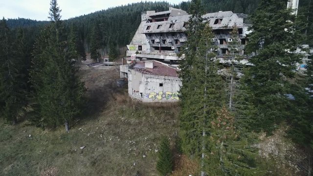 Drone shot of destructed and abandoned hotel building at Sarajevo Olympics venue in former Yugoslavia