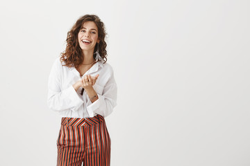 Female colleague clapping hands, applauding friend who achieved success. Portrait of happy carefree...