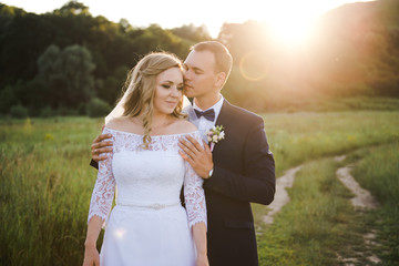 Fototapeta premium Wedding couple at sunset. The bride and groom in the mountains.