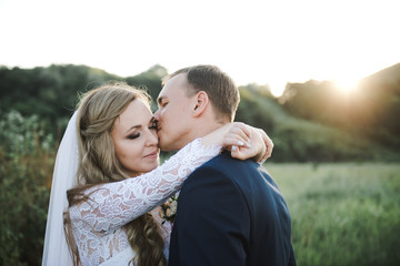 Wedding couple at sunset. The bride and groom in the mountains.