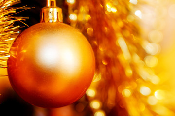 Close Up of Christmas-tree decorations. Golden color and blur background.