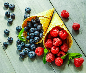 Berries in waffle cones grey background