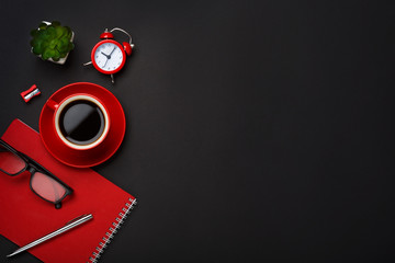 black background red coffee cup note pad alarm clock flower empty space desktop