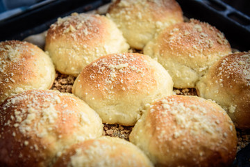 Homemade sweet yeast buns with apple jam on dark wooden background.