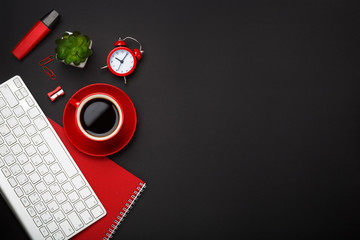 black background red coffee cup note pad alarm clock flower keyboard blank space desktop