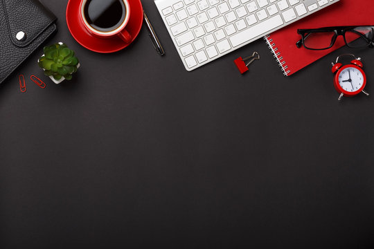black background red coffee cup note pad alarm clock flower diary scores keyboard empty space desktop