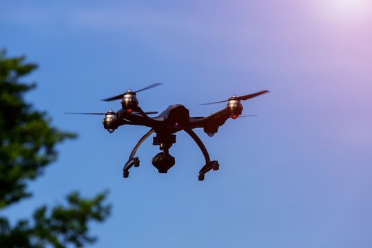 Drone or UAV flying overhead in blue sky