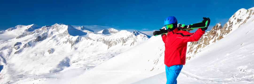 Man enjoying the stunning view before skiing in famous ski resort in Alps.