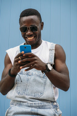 Portrait of handsome afro man using his mobile.