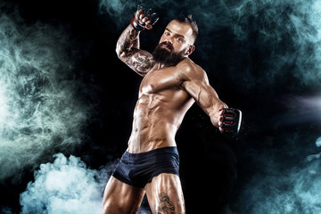 Obraz premium Sportsman boxer fighting on black background. Copy Space. Boxing sport concept.