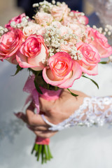 The bride is holding a wedding bouquet