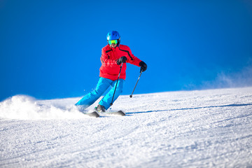 Fototapeta na wymiar Man skiing on the prepared slope with fresh new powder snow.