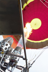 The flame of a gas burner inflates a balloon