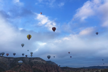 Dozens of balloons fly over the valleys in Cappadocia