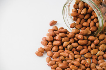 Peanuts spilled out of jar