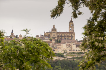 Fototapeta na wymiar viewpoint of Segovia. Gothic cathedral, Romanesque churches, aqueduct. Segovia skyline in spring, gray sky. Spain. Europe