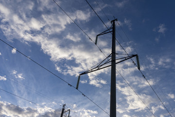 Power line against the sky with beautiful clouds