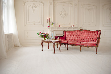 baroque style interior with red luxury sofa and table in the middle