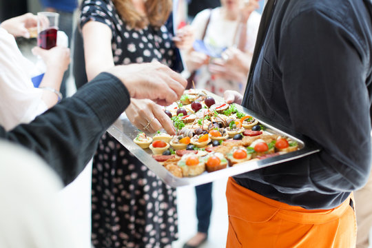 Waiter Doing Catering Service At Social Gathering