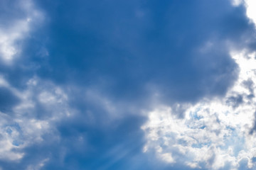 view of clouds with sun shining through