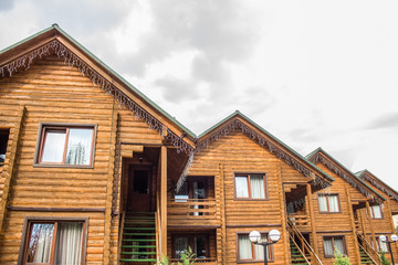 wooden cottages facade with empty white space on sky for copy or text