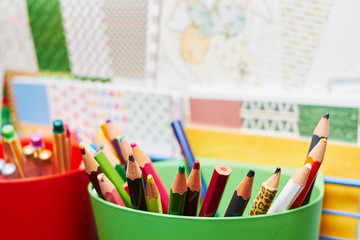 Fototapeta premium Colour pencils in a green cup