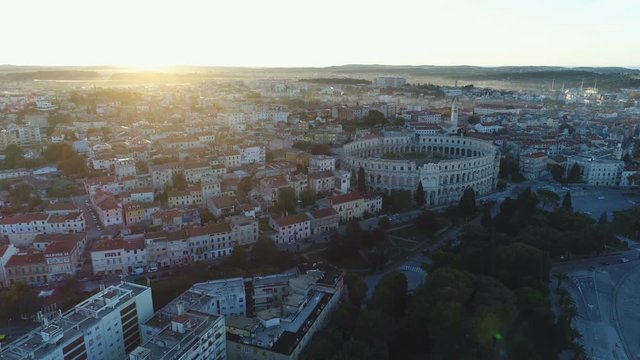 Beautiful drone shot of classic European urban landscape at sunrise, classic well preserved Pula Arena, heritage tourism travel architecture Croatia