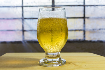 Glass of beer on a table.