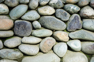 Wall of large round stones. Close-up