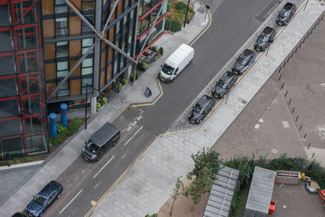 London black cabs parking in front of building, view from above.