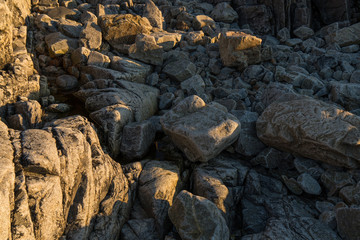 The rocky coastline at Rorvikstranda beach and Gimsoystraumen fjord at Lofoten Islands / Norway