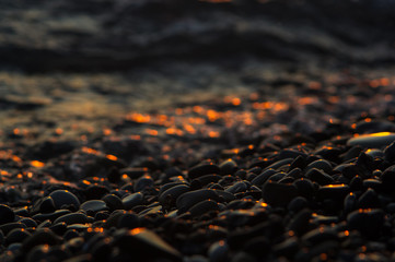 Obraz premium pebble stones on the sea beach, the rolling waves of the sea with foam