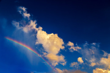 Fototapeta na wymiar Cloud look like dog walk on the rainbow with bright blue sky, sun shine day