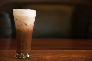 Iced coffee on a table with dark on background