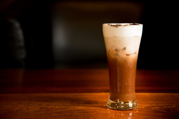 Iced coffee on a table with dark on background